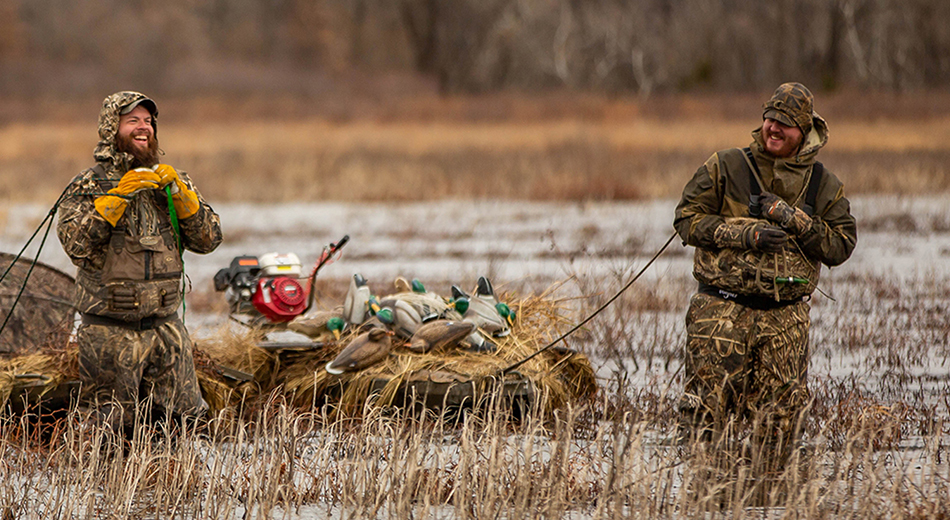 Two hunters pulling decoys