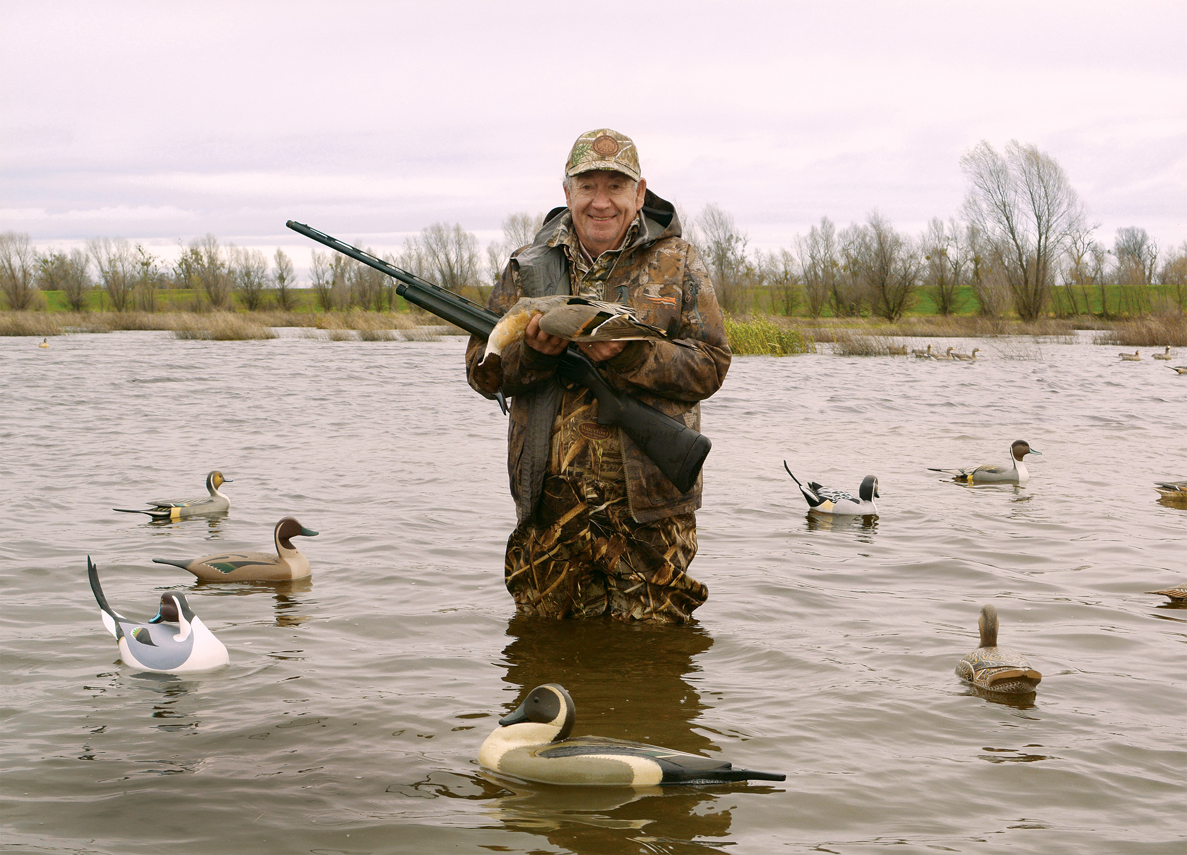 Mike Cole, a successful California rice farmer, land manager and duck club owner, poses with a pintail duck.