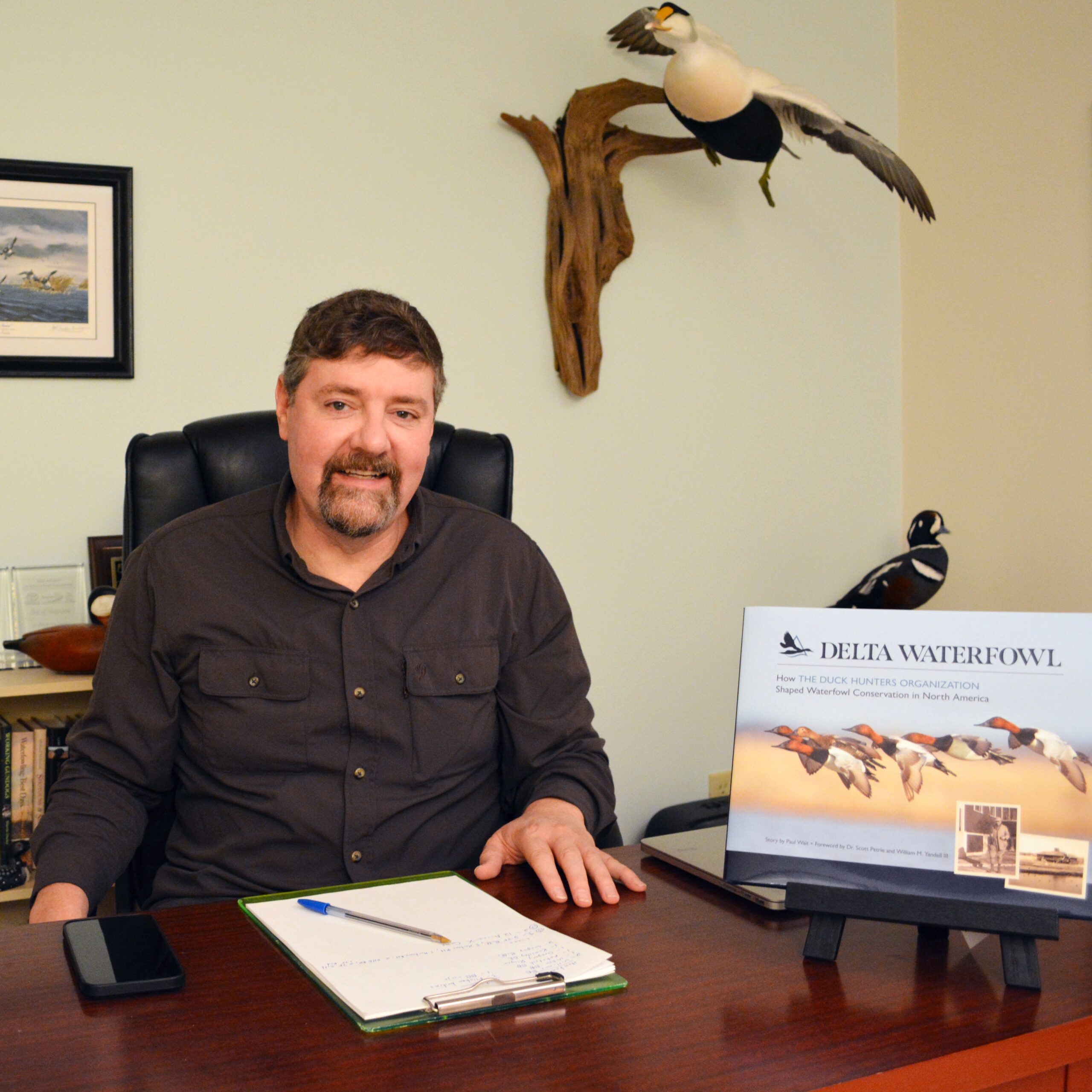 Paul Wait received an award for the book he wrote for Delta Waterfowl. He's pictured here with the book in his office.