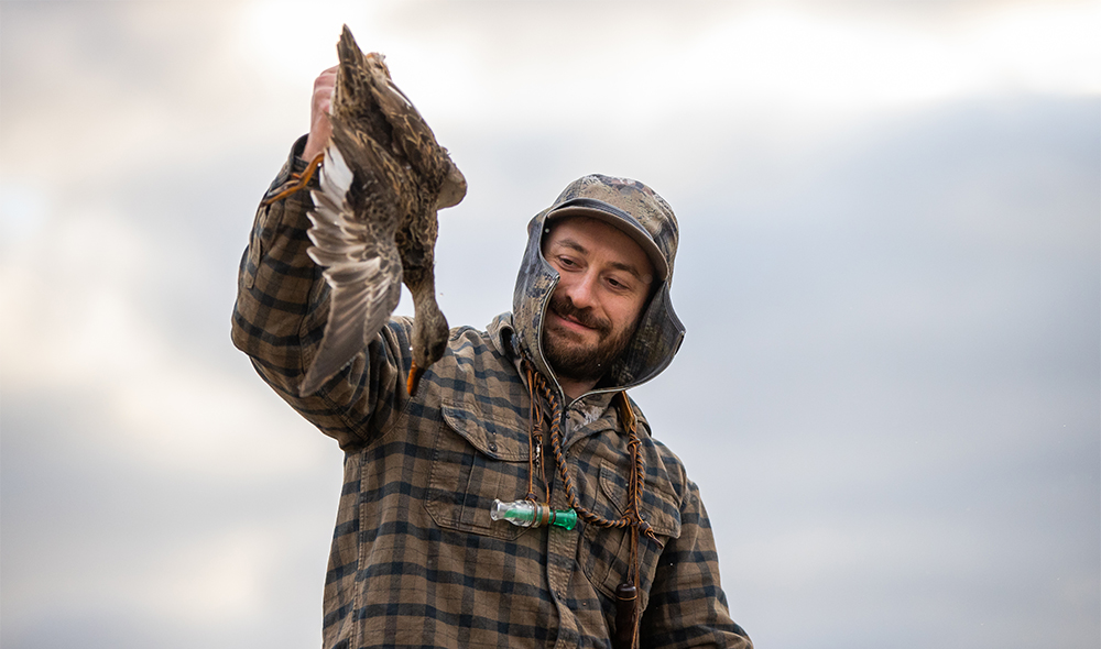 A new report by the U.S. Fish and Wildlife Service shows that hunters like this man, showing off his bird in front of a cloudy sky, contributed $45.2 billion to the economy.