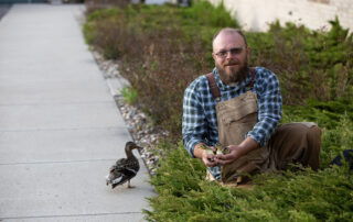 Dr. Nicolai of Delta Waterfowl holds a few eggs of a mallard hen that decided to nest in the shrubbery next to the Delta Waterfowl building.